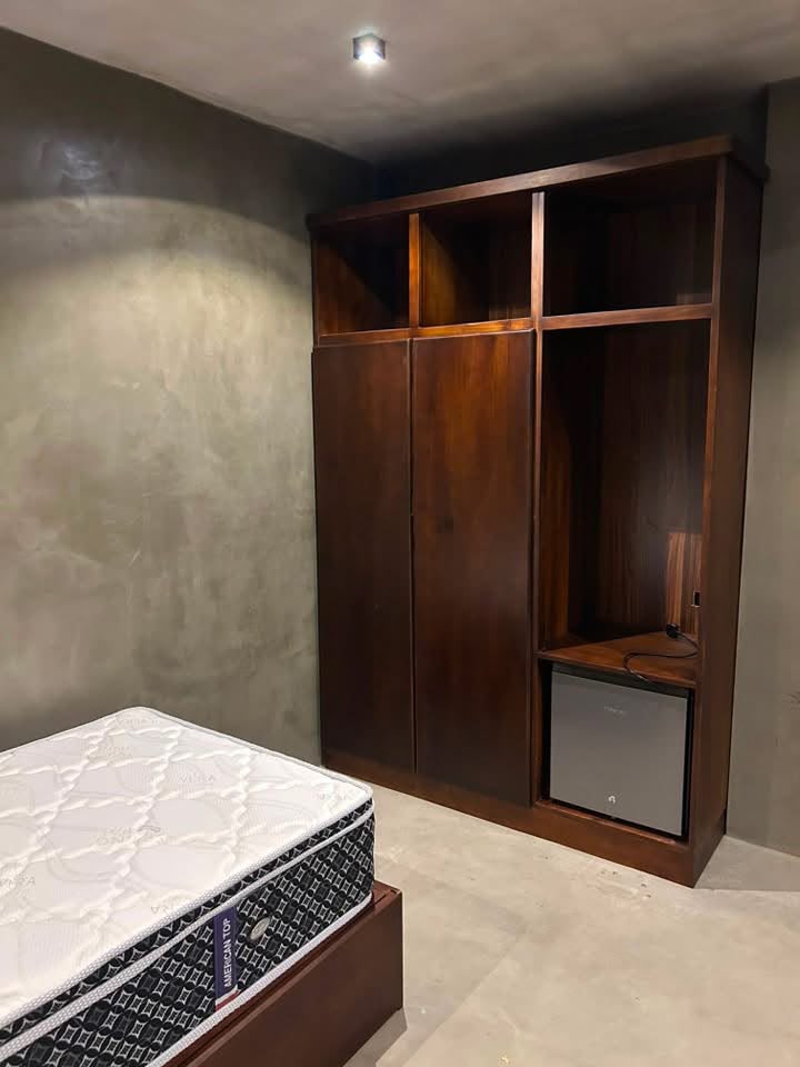 Bedroom wardrobe with open cubbies and a fridge niche