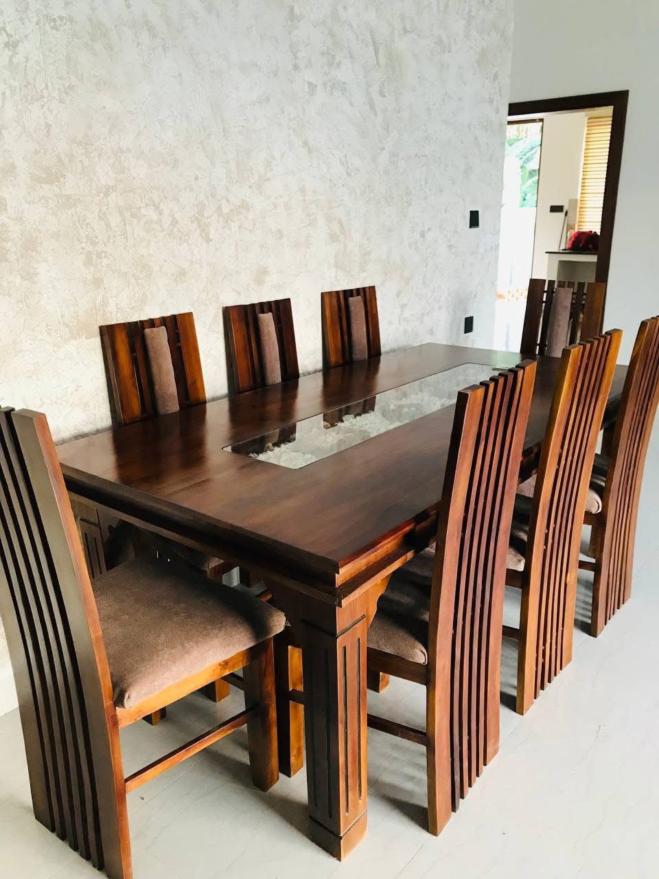 Custom solid wood dining table with eight high-back chairs